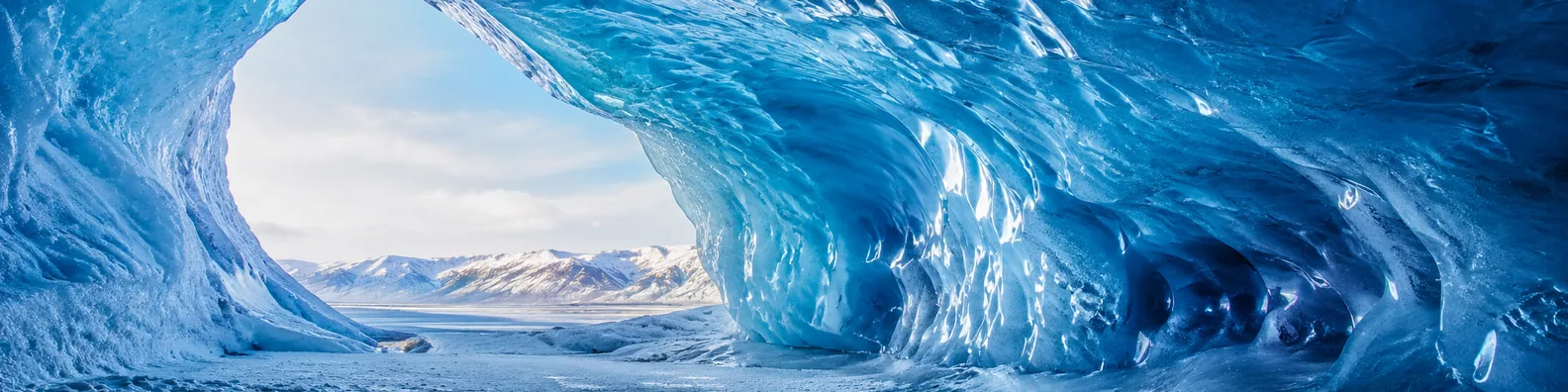 Blue ice cave LinkedIn background banner with glowing natural ice walls, frozen textures, daylight opening, and distant mountains