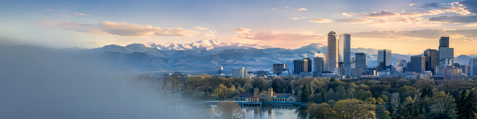 Denver skyline with mountains in the background and soft golden light LinkedIn background banner