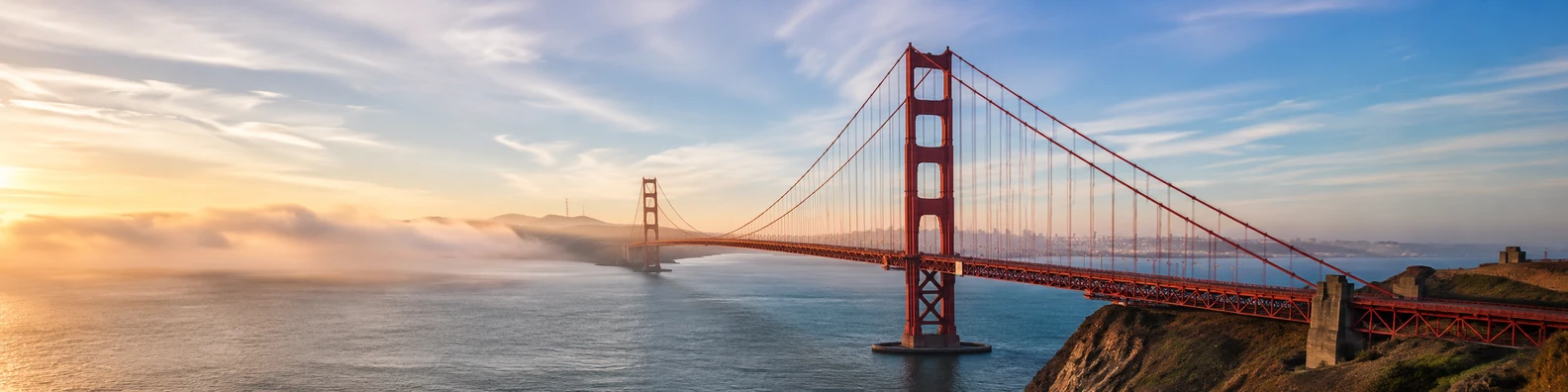 Golden Gate Bridge over the bay with soft fog and golden light LinkedIn background banner