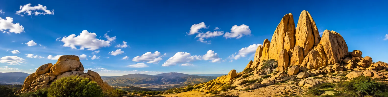 Golden stone rock formations under blue sky LinkedIn background banner