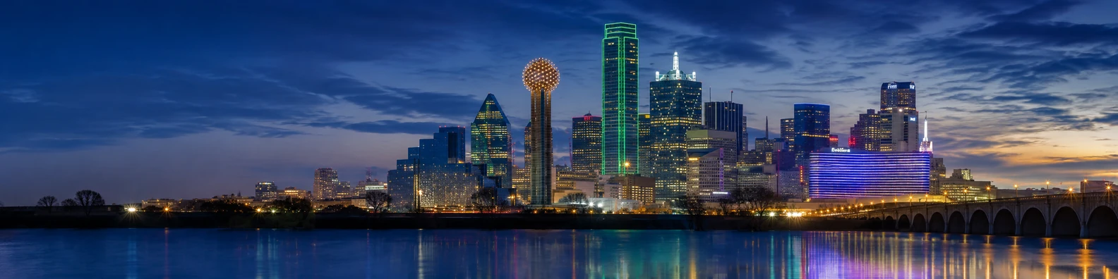 Houston downtown skyline with modern towers, evening light, and calm reflections LinkedIn background banner