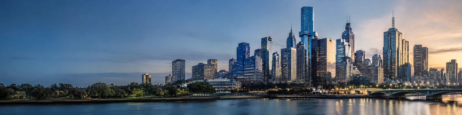 Melbourne city skyline with modern towers, soft evening sky, and waterfront reflections LinkedIn banner
