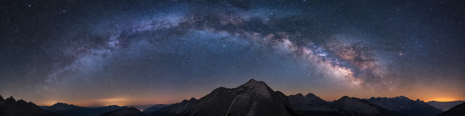 Milky Way night sky above dark mountain silhouette LinkedIn background banner