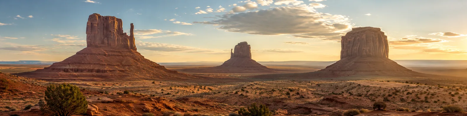 Monument Valley inspired desert LinkedIn background banner with sandstone buttes, open desert land, warm light, and wide sky