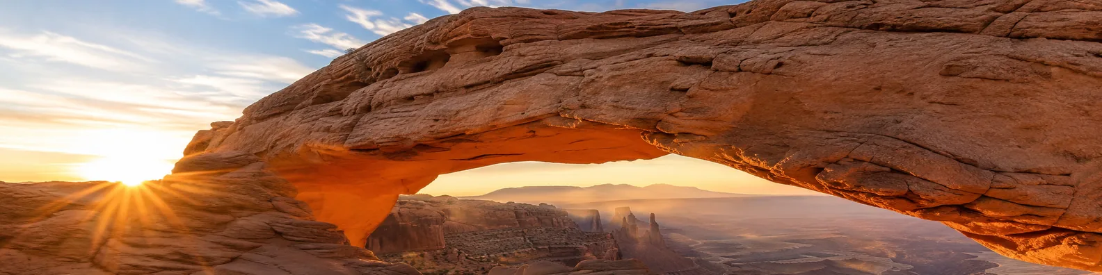 Natural stone arch landscape LinkedIn background banner with desert canyon arch, warm sunlight, open sky, and layered rock formations