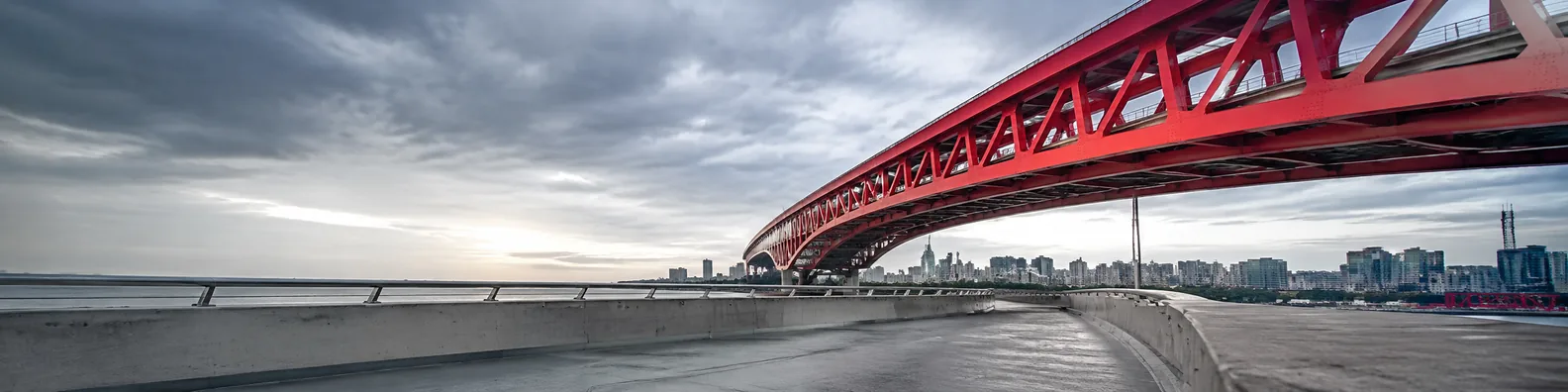 Red bridge under cloudy sky urban LinkedIn background banner
