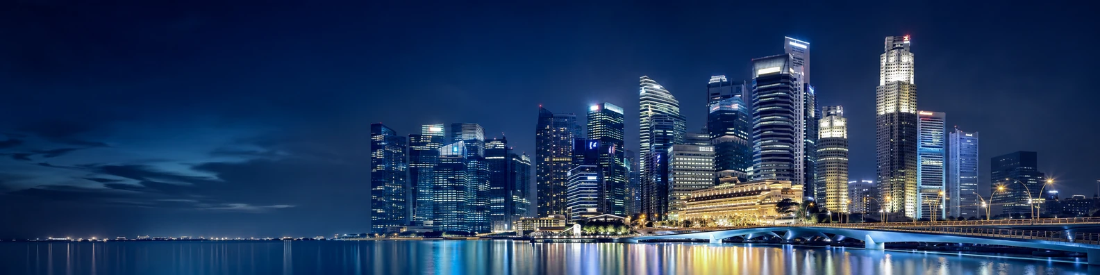 Singapore skyline night view with modern skyscrapers and calm waterfront reflections LinkedIn background banner