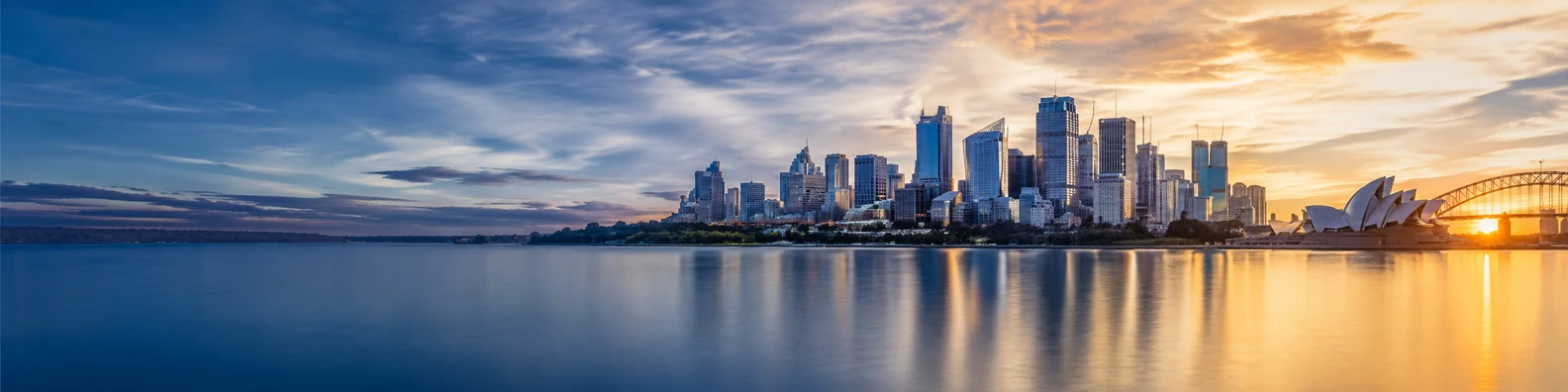 Sydney skyline harbor view with water reflections and warm evening light LinkedIn banner