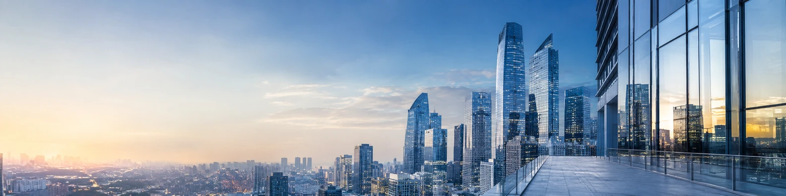 Tall buildings urban view with high-rise towers, skyline framing, and soft golden light LinkedIn banner