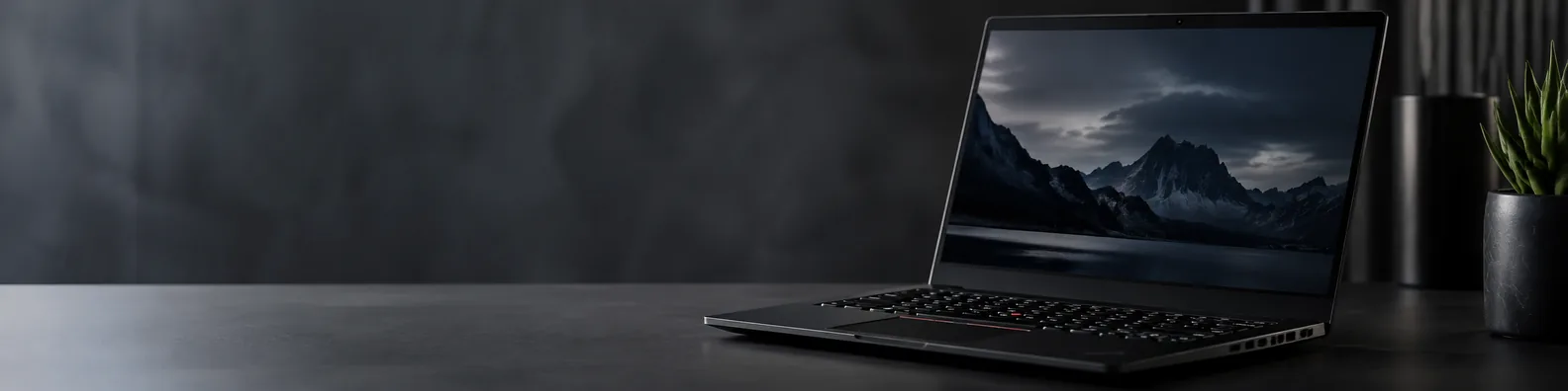 Modern Thinkpad-style laptop on a dark professional workspace with subtle lighting LinkedIn background banner