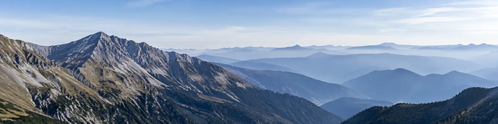 Layered mountain ranges fading into misty blue distance LinkedIn background banner