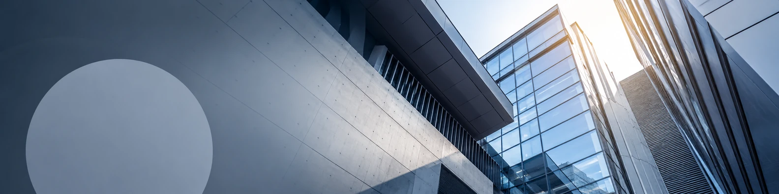 Urban architecture lines with glass and concrete structures, angled perspectives, and soft sunlight LinkedIn banner