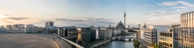 Modern Berlin cityscape with office buildings and soft evening light LinkedIn background banner