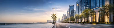 City avenue background with modern buildings, streetlights, clean sidewalks, and soft morning light LinkedIn banner