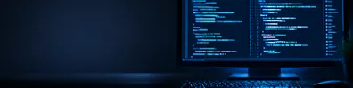 Coding screen background LinkedIn banner with blurred non-readable code, monitor glow, keyboard, and dark blue workspace