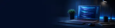 Developer laptop with code LinkedIn background banner showing blurred code on a laptop screen, keyboard, mouse, and dark blue desk setup