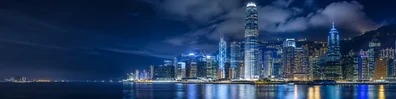 Hong Kong skyline lights at night with harbor reflections and dense high-rise buildings LinkedIn banner