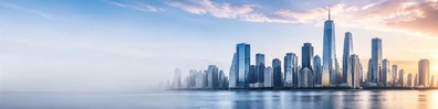 Modern city skyline background with tall glass towers, soft sky, and calm waterfront reflections LinkedIn banner