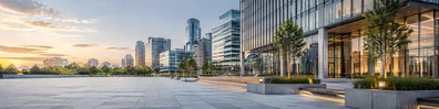 Modern urban plaza with glass office buildings and warm daylight LinkedIn background banner