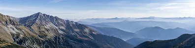 Layered mountain ranges fading into misty blue distance LinkedIn background banner