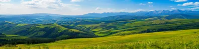 Rolling green hills and distant mountain layers under a bright sky LinkedIn background banner