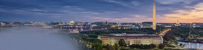 Washington DC city skyline with government-style architecture and warm dusk light LinkedIn background banner