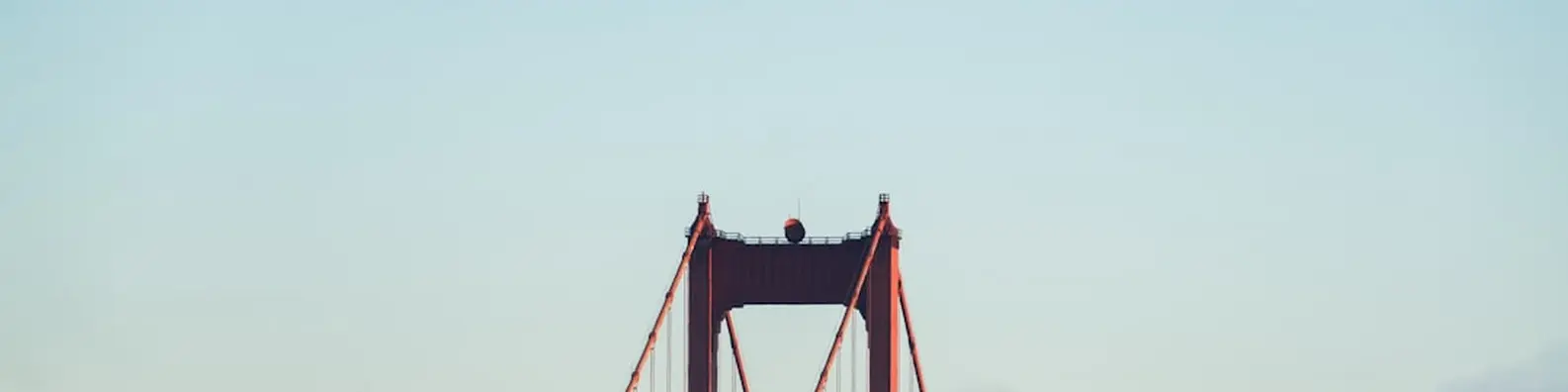 Red Concrete Bridge in Cloudy Sky